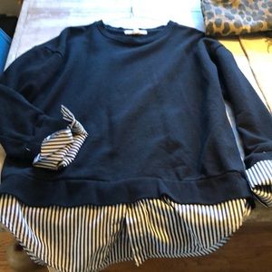 Black sweatshirt with pinstripe attaches blouse